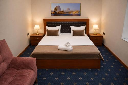 a hotel room with a bed with a towel on it at Porto Bistro in Baku