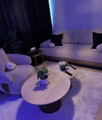 a living room with a couch and a table at Faith hot in Courcouronnes