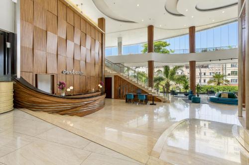 a lobby of a building with a large staircase at Sunday Hotel Antero Jababeka in Cikarang