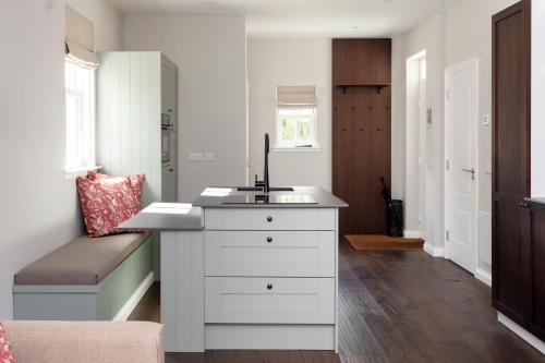 a kitchen with a white counter and a sink at Roxburghe Cottages, part of Destination by Hyatt in Kelso
