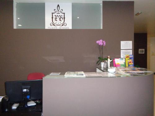 an office with a counter with a flower on it at Hotel Villa De Betanzos in Betanzos