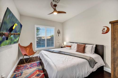 a bedroom with a bed and a ceiling fan at Luxury and Harmony in a 6BR Dream Villa; Pool, Hot Tub, Game room, Near the Las Vegas Strip in Las Vegas