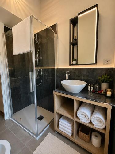 a bathroom with a glass shower and a sink at Borgo Carla in Massa