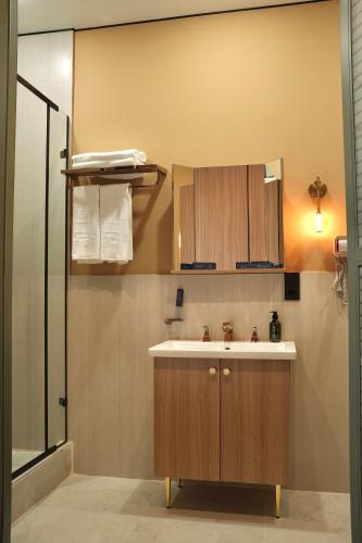 a bathroom with a sink and a shower at Monteva Boutique Hotel in Almaty