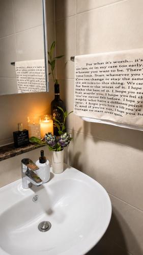 a bathroom with a white sink and a mirror at La Casa Verde in Seoul