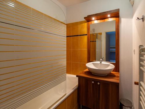 a bathroom with a sink and a mirror at Les Chalets d Ax N 303 - 2P4C in Ax-les-Thermes