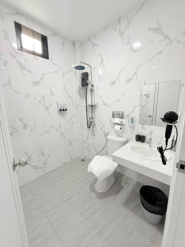 a white bathroom with a toilet and a sink at Hana residence Bangtao BeachBangtao 11 Phuket in Ban Thalat Choeng Thale
