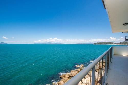 a view of the ocean from a balcony at 1 Bright Point Apartment 5301 in Nelly Bay