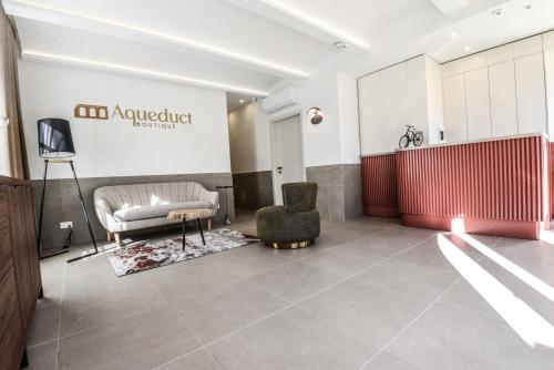 a lobby with a chair and a stage in a building at Aqueduct Boutique B&B in Victoria