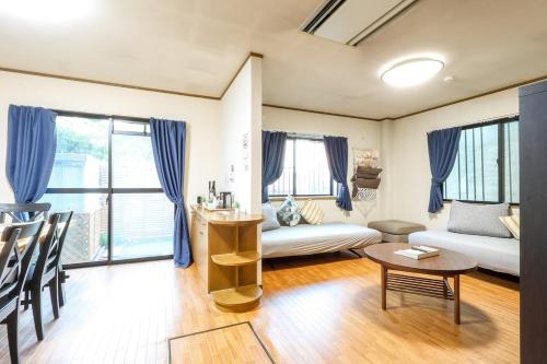 a living room with a couch and a table at お宿 しんみち in Nagoya
