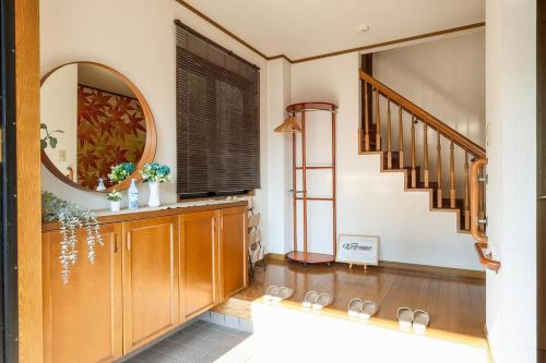 a hallway with a staircase and a mirror at お宿 しんみち in Nagoya