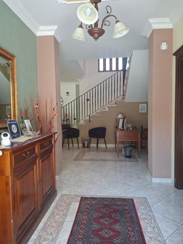 a hallway with a staircase and a living room at B&B TENUTA BIANCA in Oliveto Citra