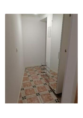 an empty room with a tile floor and a staircase at Central City nest in Haparanda