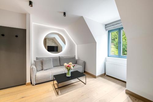 a living room with a couch and a table at Residenz Boutique Suites in Bad Gastein