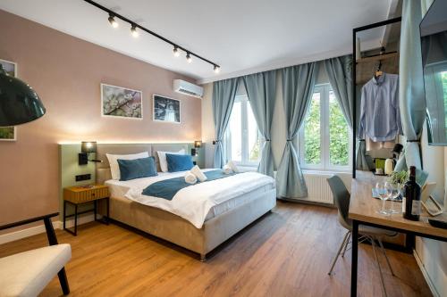 a bedroom with a bed and a desk at Luxury Apart-Hotel in Bucharest