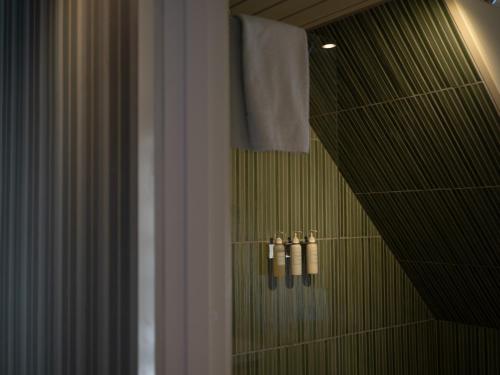 a bathroom with a shower with three candles in it at Nørby Boutique Hotel in Fanø
