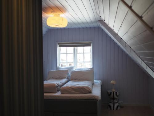 a couch sitting in a room with a window at Nørby Boutique Hotel in Fanø