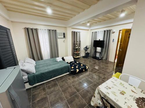 a bedroom with a bed and a tv in it at The Uptown deluXE Studio #5 in Balulang