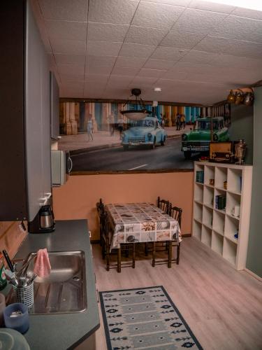 a kitchen with a table and a kitchen with a car at Kiinteistö Hetekka in Kouvola