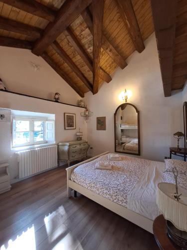 a bedroom with a large bed and a mirror at Antico Chalet Momosa Maxi in Ovindoli