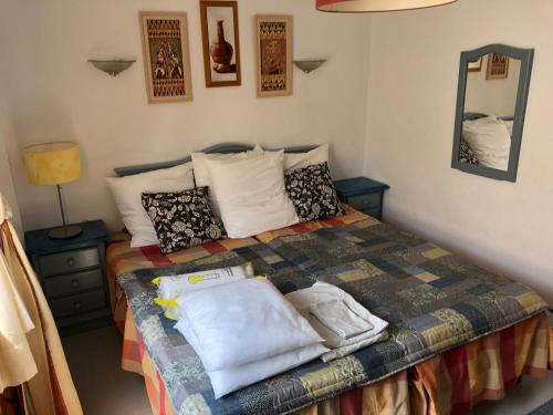 a bedroom with a bed with pillows on it at Veracoast 133 in Los Amarguillos