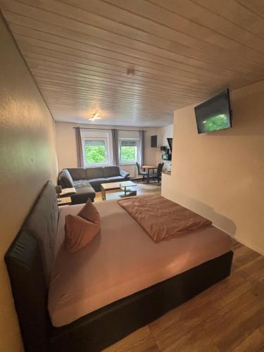 a living room with a bed and a couch at Pension Flying Ranch in Dermsdorf