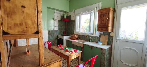 a kitchen with a table and a small table with chairs at Mama's Home in Chios