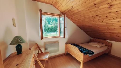 a bedroom with a bed and a window at Gite De La Mortagne in Mortagne