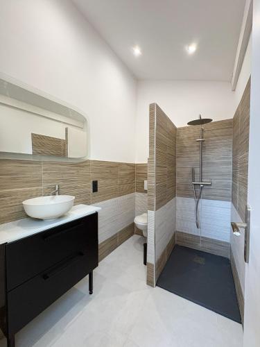 a bathroom with a sink and a shower at L'échappée verte in Chirens
