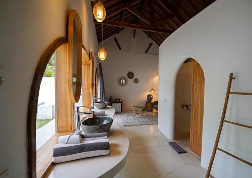 a bathroom with a sink in the middle of a room at Lombok Souls in Senggigi