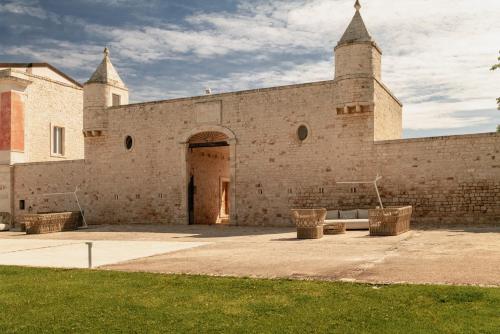 a large brick building with a door and two towers at Relais Il Santissimo in Turi