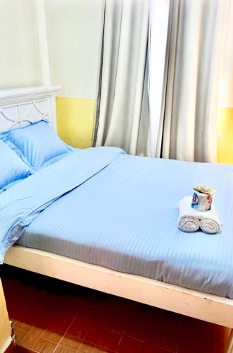 a bed with two towels sitting on top of it at Tranquil stays in Bungoma