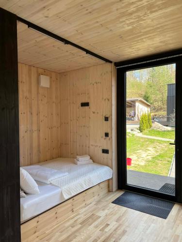 a bed in a room with a large window at Premium homes in VNO