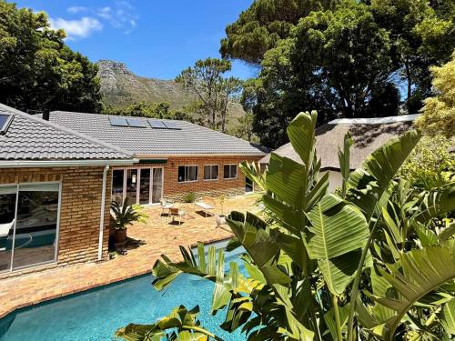 a house with a swimming pool in front of it at Tranquility in Cape Town