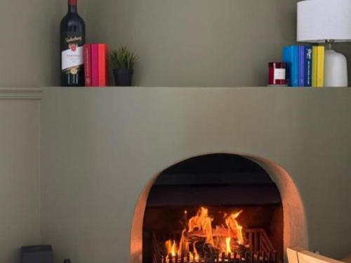 a fireplace with a fire inside of it at Tranquility in Cape Town