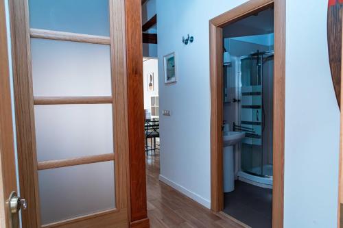 a glass door with a wooden frame in a hallway at Piso en Casa de Correos in Molina de Aragón