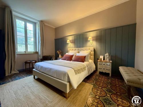 a bedroom with a large bed and a window at Un brin lavande in Saint-Couat-dʼAude