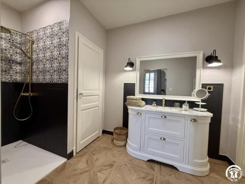 a bathroom with a sink and a mirror and a shower at Un brin lavande in Saint-Couat-dʼAude