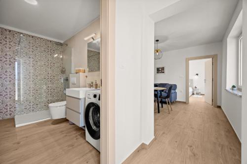 a kitchen and living room with a washer and dryer at Danijela Holiday Home in Labin
