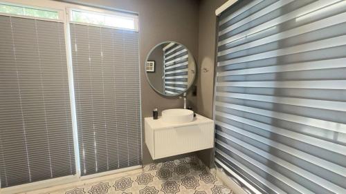 a bathroom with a mirror and a white sink at Mountain Valley Oludeniz in Oludeniz