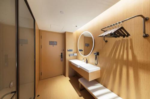 a bathroom with a sink and a mirror at JI Hotel Beijing Xizhimen in Beijing