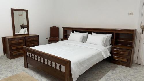 a bedroom with a large bed and a mirror at Beachfront Villa Sea View First Row in Dawwār ‘Abd Allāh