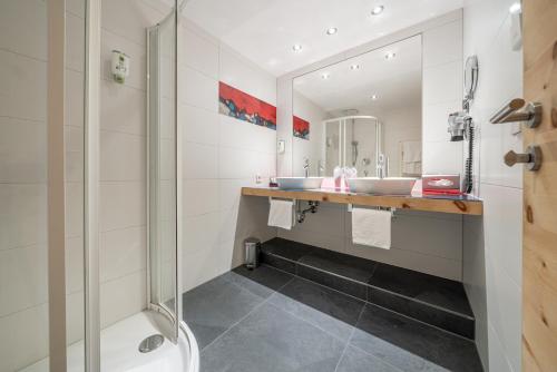 a bathroom with two sinks and a shower at Naudererhof - 4-Stern-Superior in Nauders