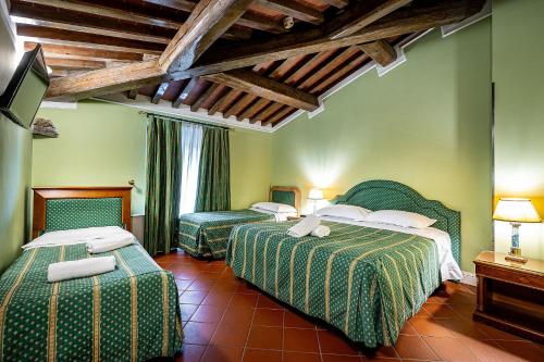 a hotel room with two beds in a room at Grand Hotel Panama Firenze in Florence