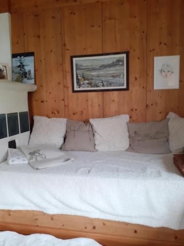 a large bed in a room with wooden walls at Bergblick in Schwaz