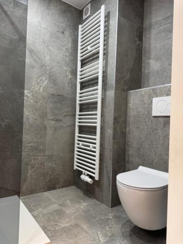 a bathroom with a white toilet in a room at Arku apartments Brussels Airport in Zaventem