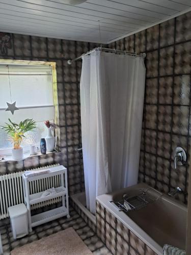 a bathroom with a tub and a shower curtain at Bergblick in Schwaz