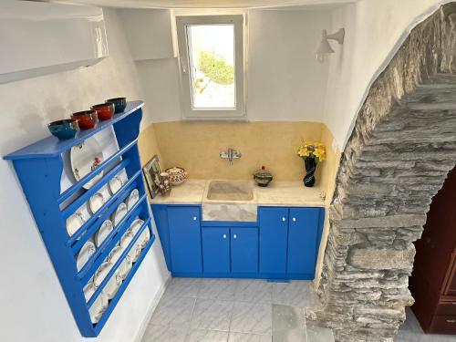 a kitchen with a sink and a blue cabinet at Tinos Sunset Villa in Kékhros