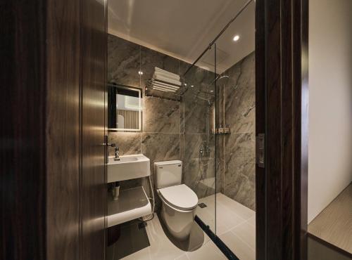a bathroom with a toilet and a sink and a shower at Luckin Hotel Lê Đức Thọ by Urban B in Ho Chi Minh City