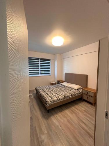 a bedroom with a bed and a window at Two-room apartment in Dudu